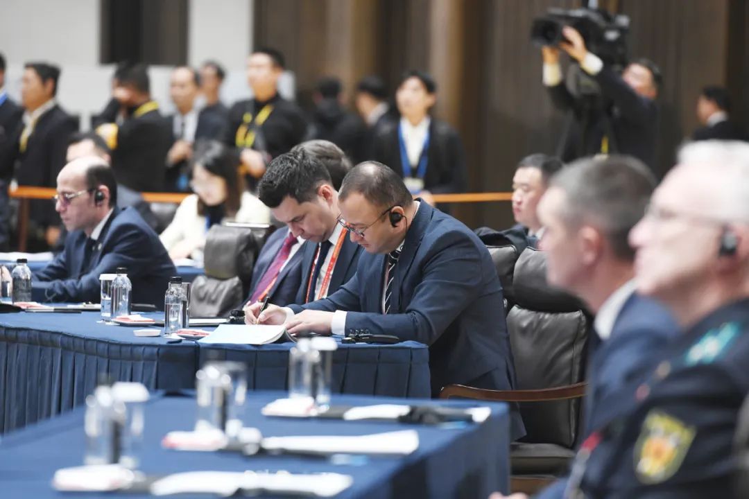 Attendees take notes during the conference.