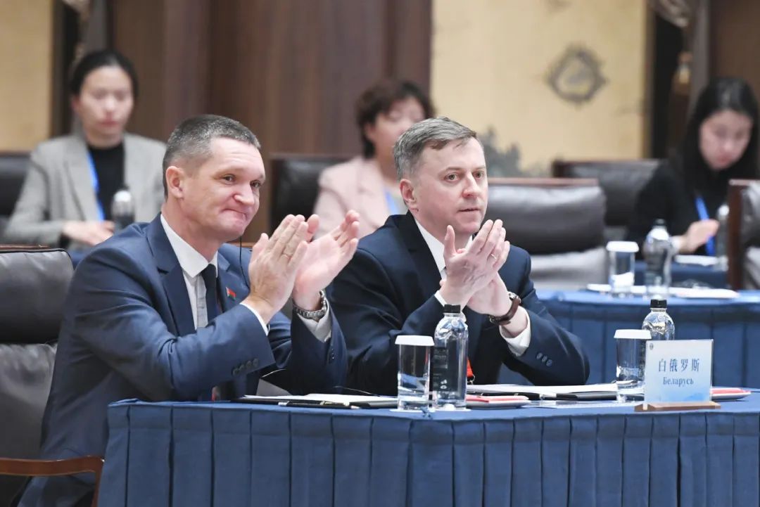 Members of the Belarusian delegation applaud during a speech. 