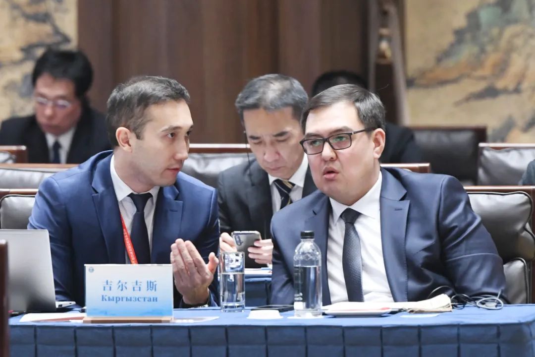 Members of the Kyrgyz delegation exchange ideas before the conference.